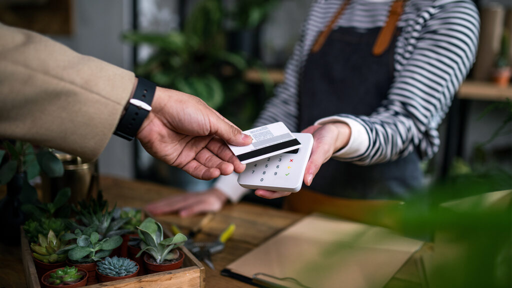 Customer payong in potted plant store, small business and contactless payment concept