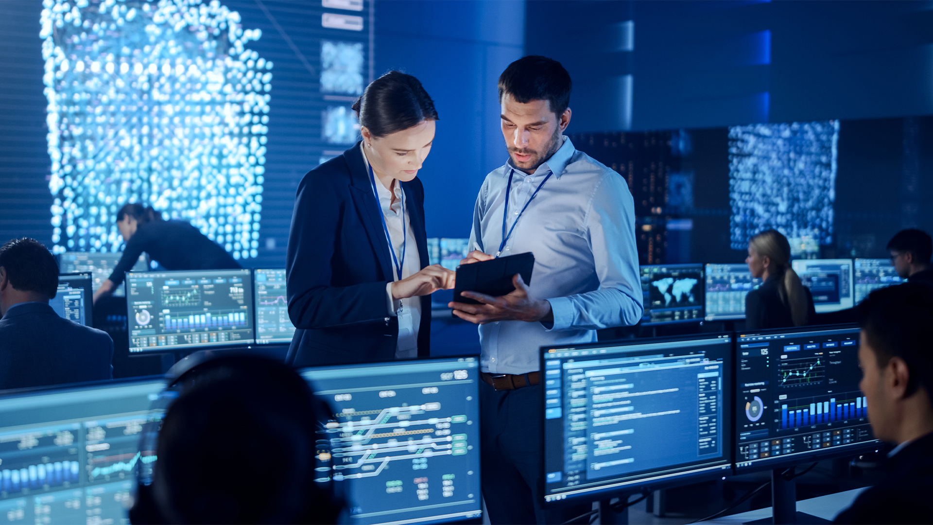 Project Manager and Computer Science Engineer Talking while Using A Digital Tablet Computer