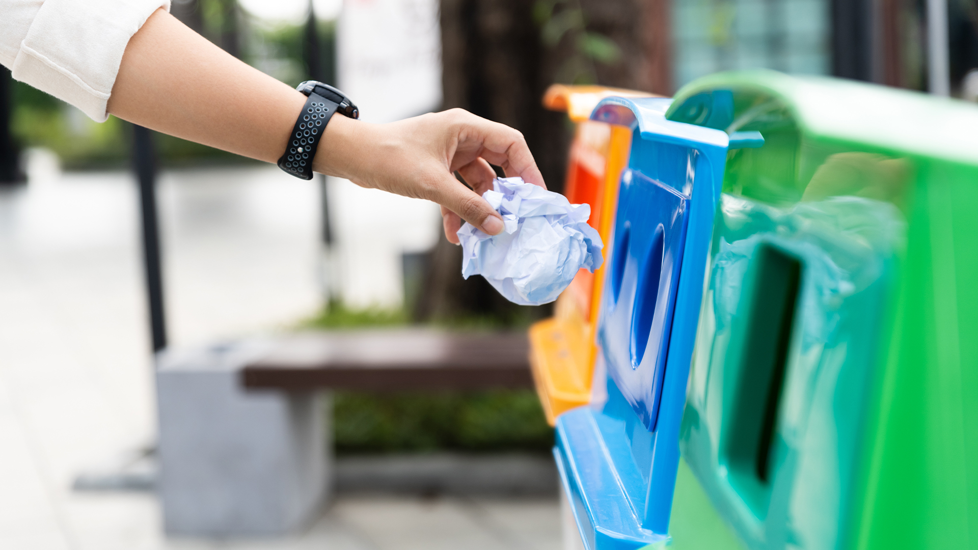 Closeup portrait woman hand throwing crumpled paper in recycling bin