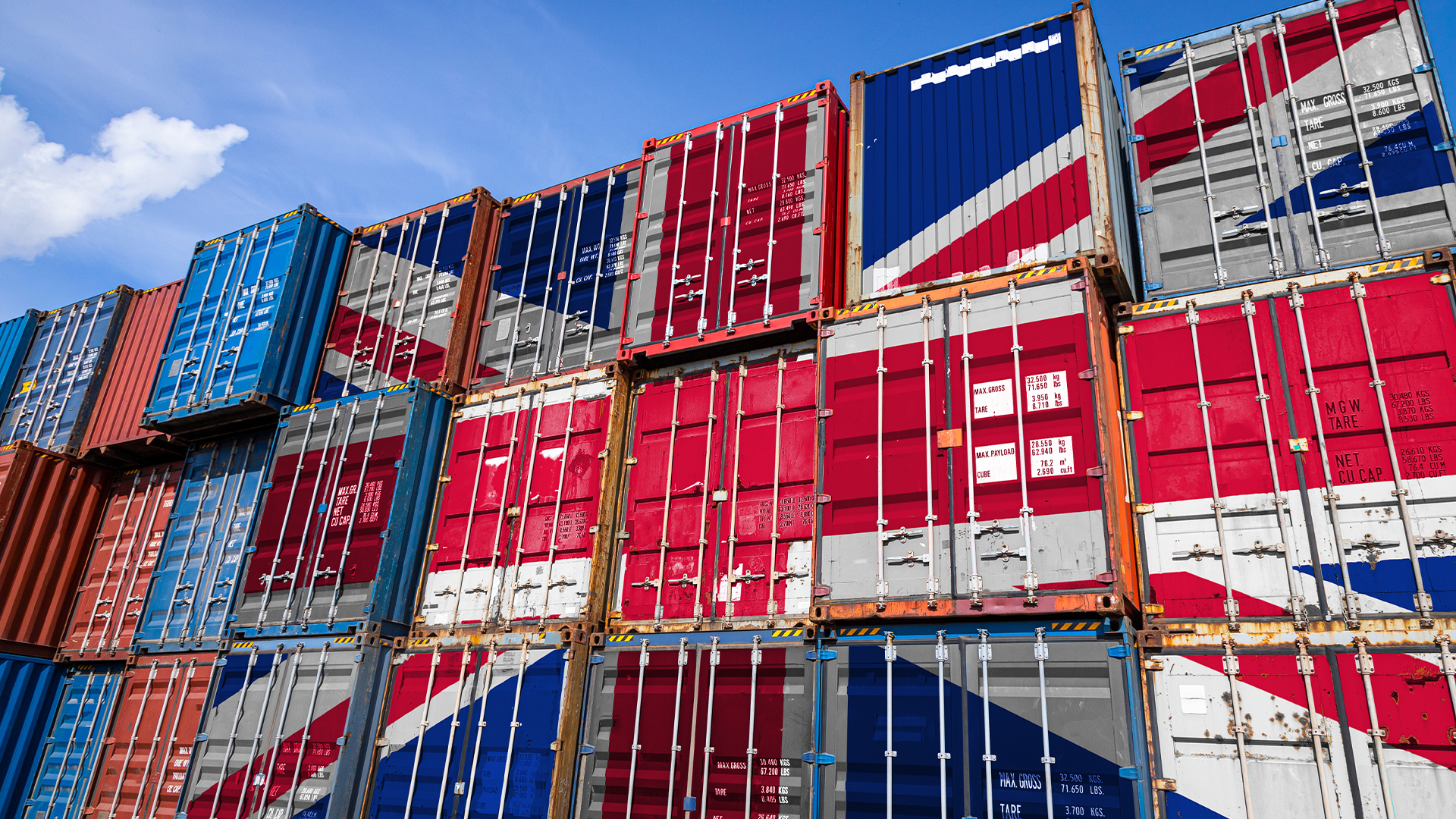 The national flag of United Kingdom on a large number of metal containers for storing goods stacked in rows on top of each other