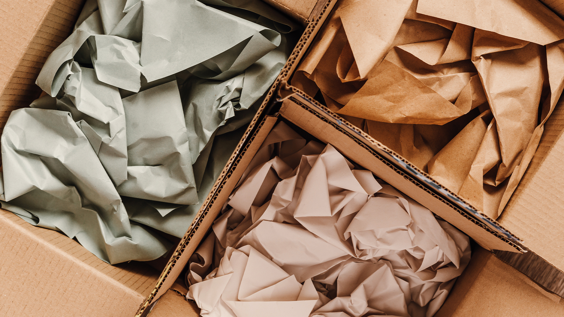 Cardboard boxes with crumpled paper inside for packaging goods from online stores